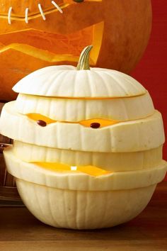 a carved pumpkin sitting on top of a wooden table