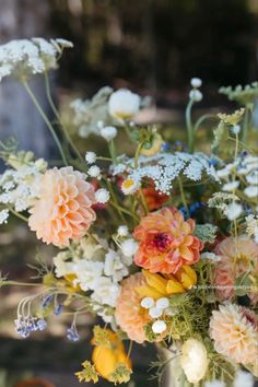 a vase filled with lots of different colored flowers