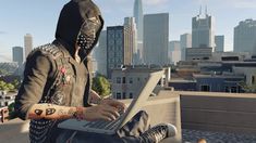 a person in a hoodie using a laptop on top of a roof with the city skyline behind them