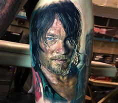 a man's leg with an image of the walking dead on it and his face