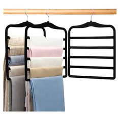 two racks with clothes hanging on them next to each other