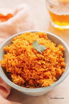 a blue bowl filled with rice and garnished with cilantro on top