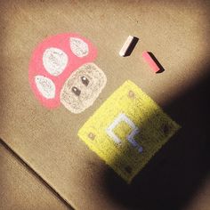 a child's drawing on the ground with crayons