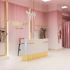 a pink and gold store front with clothes hanging on the wall, two mannequins in the background