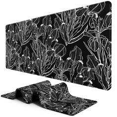 a black and white floral wallpaper with an abstract design on the back, along with two matching place mats