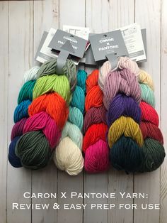 several skeins of yarn are displayed on a white wooden background with the text, carbon x pantone yarn review & easy prep for use