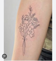 a black and white flower tattoo on the right arm, with flowers in it's center