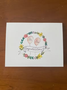 a card with two balloons and flowers on it that reads, mr and mrs congratulations