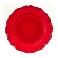 a red plate with scalloped edges on a white background