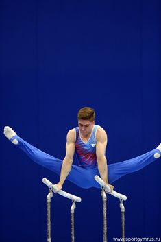 a man is doing gymnastics on the parallel bars