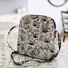 a black and white bag sitting on top of a counter