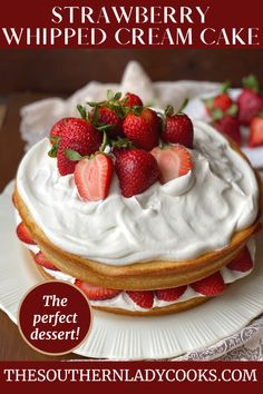 there is a cake with strawberries on top and the words, strawberry whipped cream cake