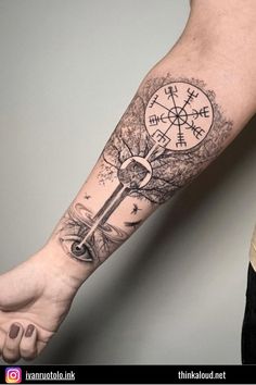 a man's arm with a compass tattoo on it and an anchor in the middle