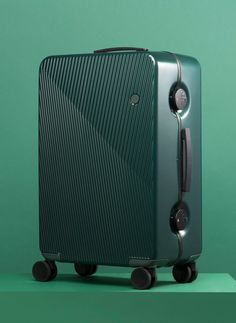 a green piece of luggage sitting on wheels