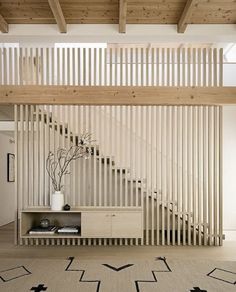 a living room filled with furniture next to a stair case