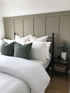 a white bed topped with lots of pillows