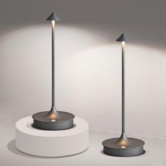 three modern lamps on pedestals with dim lighting