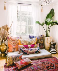 a living room filled with lots of colorful pillows