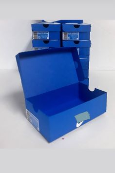 two blue boxes are stacked on top of each other, one is open and the other is closed