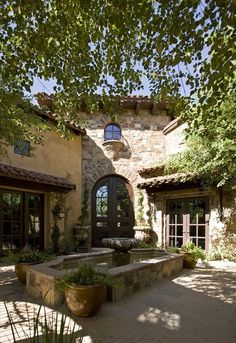 an outside view of a house with a fountain