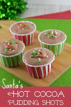 three cupcakes with chocolate frosting and sprinkles on a wooden tray