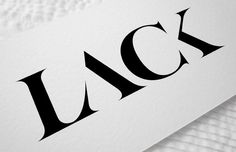 a close up view of the logo on a white paper with black letters that spell out lacc