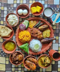 an overhead view of several dishes on a table with eggs, rice and other food items