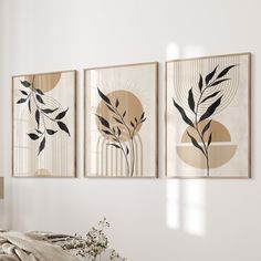 three framed art pieces hang on the wall above a bed