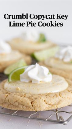 a close up of a cookie on a cooling rack with limes and whipped cream