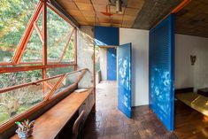 the inside of a house with blue doors and windows on either side of the room