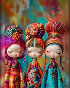 three little dolls with colorful hair are standing next to each other and looking at the camera