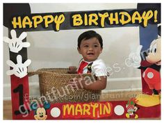 a young boy is sitting in front of a mickey mouse photo frame with the words happy birthday