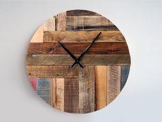 a clock made out of wooden planks on the wall