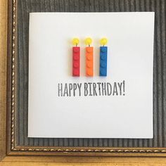 a birthday card with lego candles on it in a frame that says, happy birthday