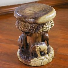 a wooden stool sitting on top of a hard wood floor