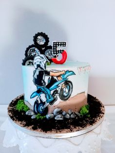 a birthday cake with a motorcycle theme on it's side and the number five