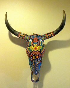 a bull's skull decorated with multicolored beads