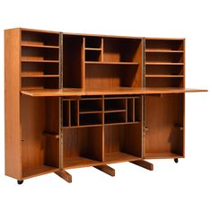 a wooden bookcase with multiple compartments and wheels