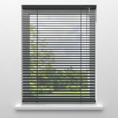 a window with the blinds closed and trees in the background