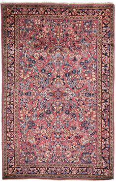 an antique persian rug with red and blue colors