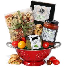 a red colander filled with assorted food items