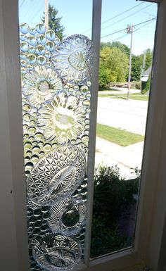 a frosted glass door in front of a window on the side of a house