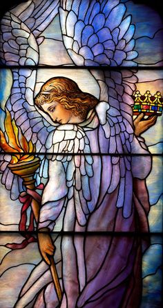 a stained glass window with an angel holding a candle in it's right hand