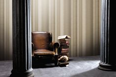 an old chair sitting next to a stack of books