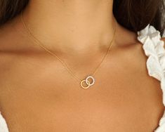 "Feel divine in this Intertwined Two-Toned Circles Necklace. This piece is simple yet stunning with one circle covered in 1/5tcw diamonds. It enriches your style with the most exquisite touches of elegance. This winsome pendant is stationed on a 14kt yellow gold link chain. With interlocking circles, one is crafted in brushed yellow gold, and the other is forged in white gold with sparkling white diamonds for a gorgeous two-toned effect. This unique pendant can be paired with other pieces bringing a refined look to any outfit. 100% Handmade in Boca Raton, FL Each necklace is made to order.  Production time: Please allow 5-7 days Stone Type: Natural Diamonds Total Carat Weight: 0.18 Diamond color: H Diamond clarity: I3 Necklace Length: 16\" with 2\" extender Clasp Type: Lobster Claw  Averag Fine Jewelry Open Circle For Wedding, Fine Jewelry For Wedding, Open Circle Style, Yellow Gold Open Circle Jewelry For Wedding, Two Tone Necklace, Amman Outfits, Bday Wishlist, Eternity Necklace, Interlocking Circle Necklace, Diamond Circle Pendant