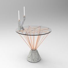 a glass table with two candles on it and some wire in the middle that is connected to each other