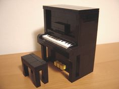 a toy piano and stool made out of legos