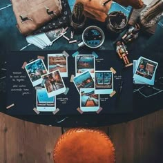 a table topped with lots of cards and other things on top of it next to a brown leather chair