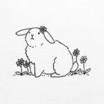 a black and white drawing of a bunny sitting on the ground with flowers in front of it