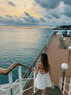 a woman is walking down the stairs on a cruise ship